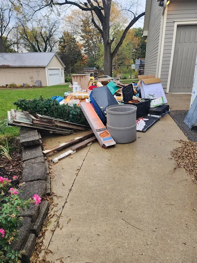 Dumpster being loaded with debris for Residential Dumpster Rental in Howland Center